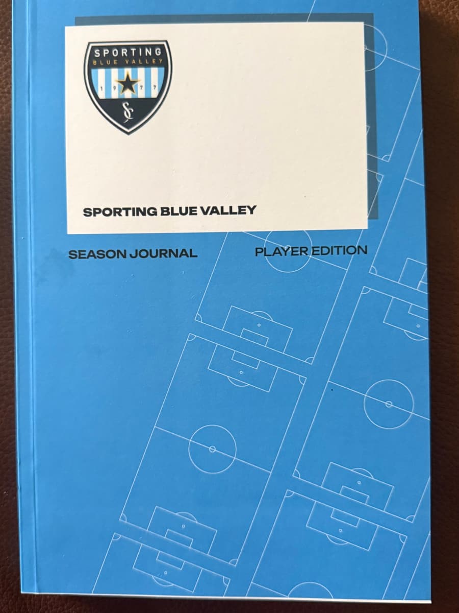 The Sporting Blue Valley Season Journal, Player Edition: a sky-blue softcover with the SBV crest and soccer field lines